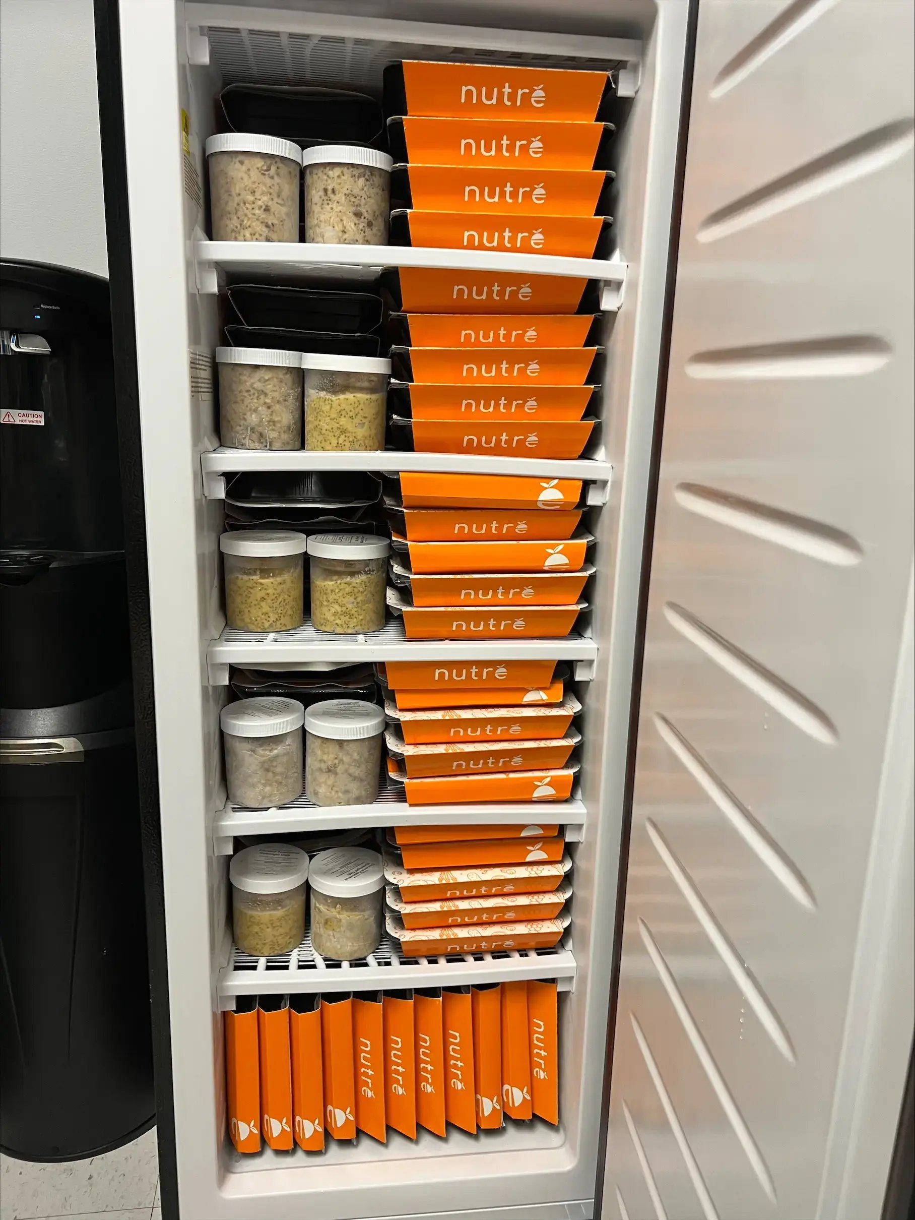 Nutre smart fridge stocked with fresh meals in a modern office