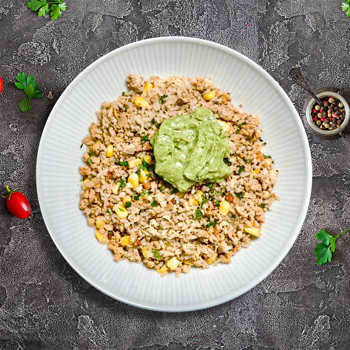 Ground chicken taco bowl with cauliflower rice, guacamole and fresh toppings