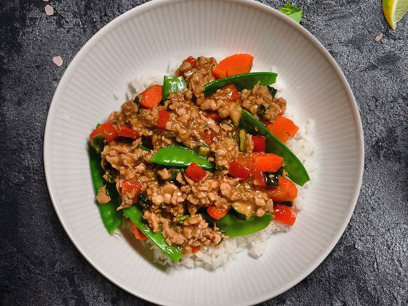 Juicy, tender antibiotic-free chicken thighs sautéed with crisp snow peas, vibrant red bell peppers, zucchini, and carrots in a rich, savory sauce of coconut aminos, tamari, toasted sesame oil, fresh ginger, and garlic.