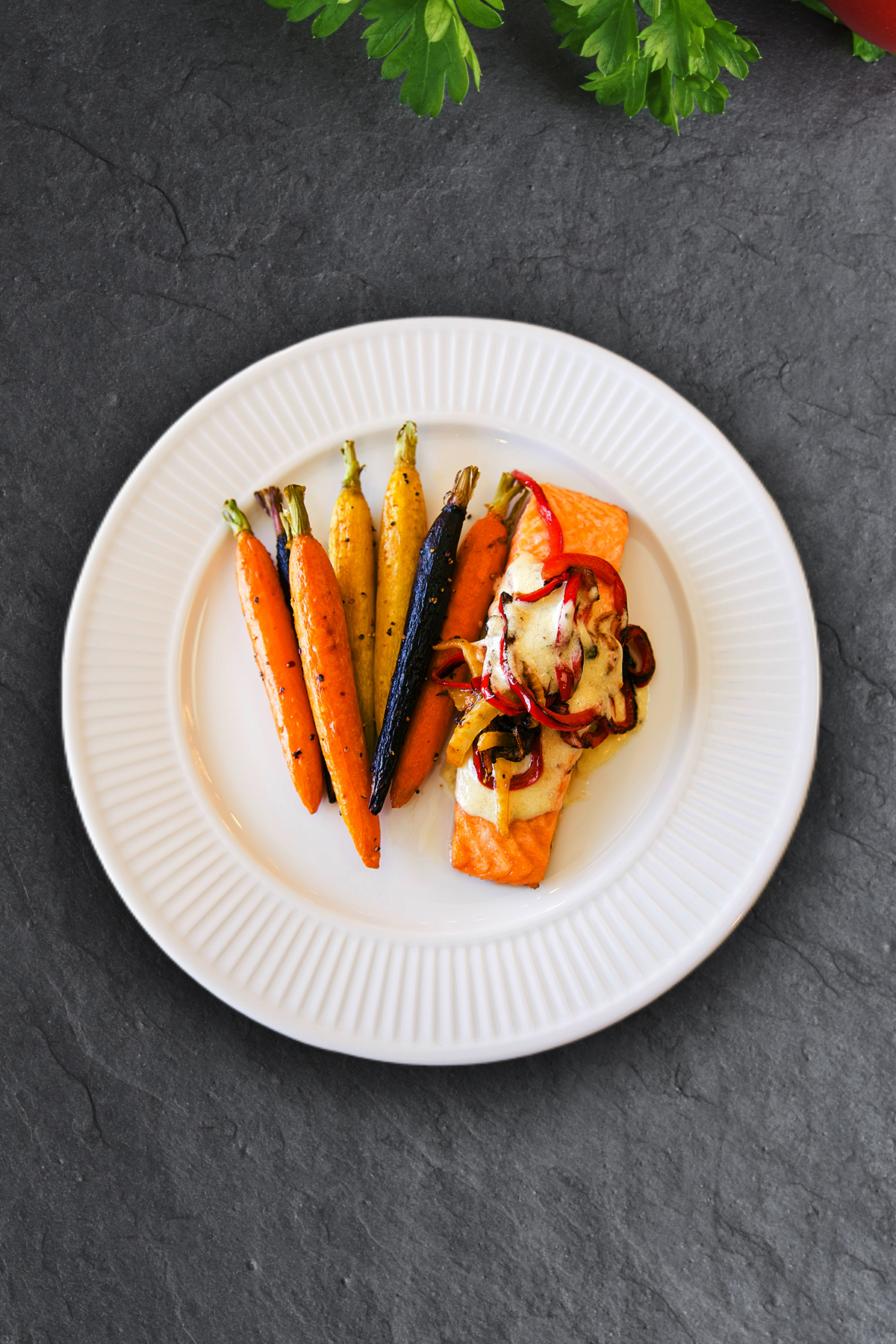 Perfectly Pan-seared salmon served with a silky lemon beurre blanc sauce, served alongside a medley of roasted tri-colored carrots.