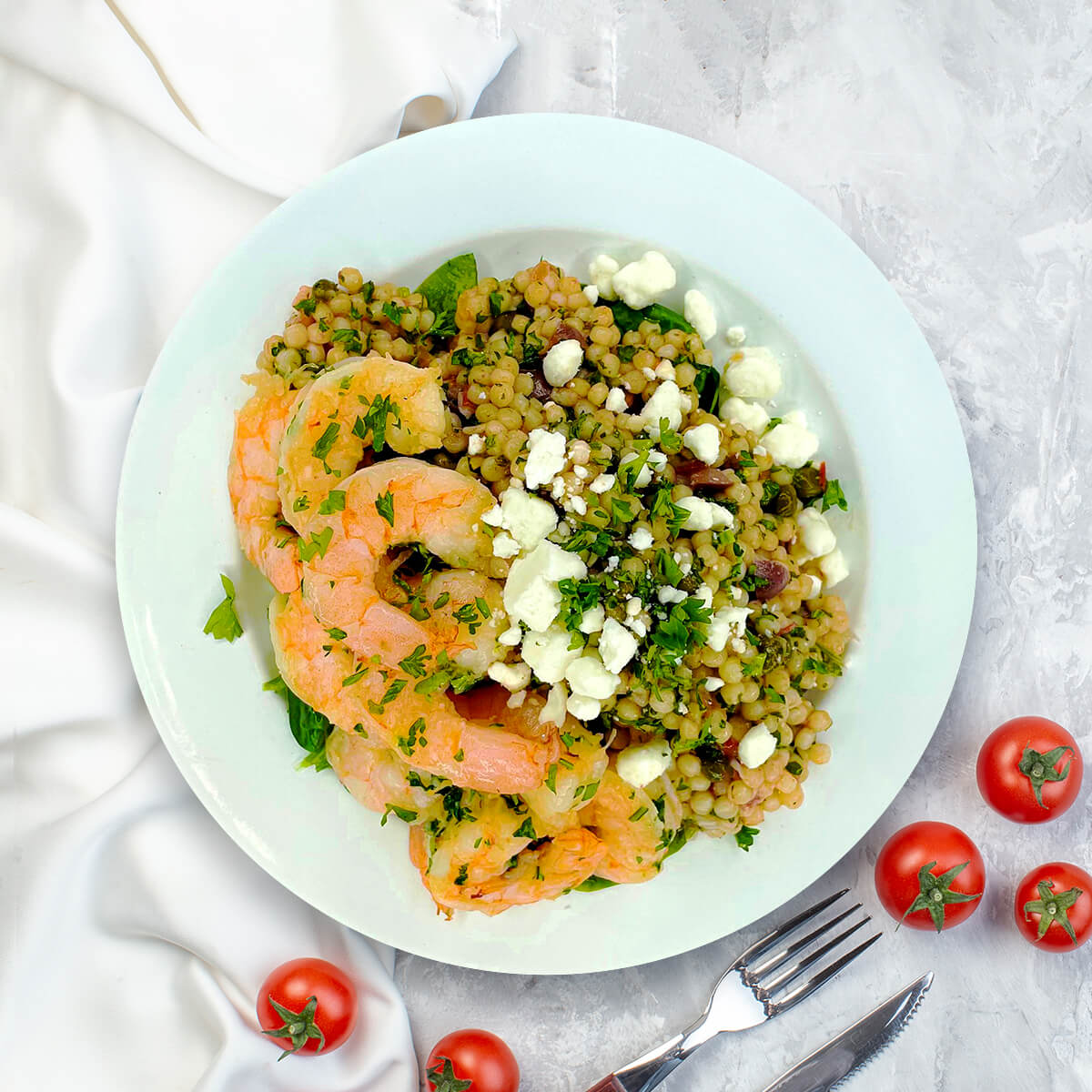 A light yet deeply satisfying Mediterranean-inspired bowl built on a foundation of tender Israeli couscous, cooked in a rich, homemade antibiotic-free chicken stock for layers of savory depth.