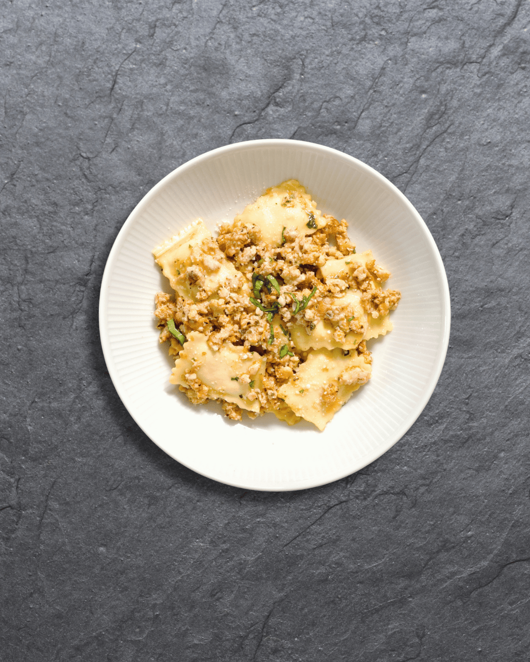 Handmade four-cheese ravioli filled with a rich blend of ricotta, mozzarella, fontina, and pecorino served in a light, nourishing vegetable broth with organic chicken sausage, butternut squash, zucchini, green beans, Roma tomatoes, carrots, celery, and potato.