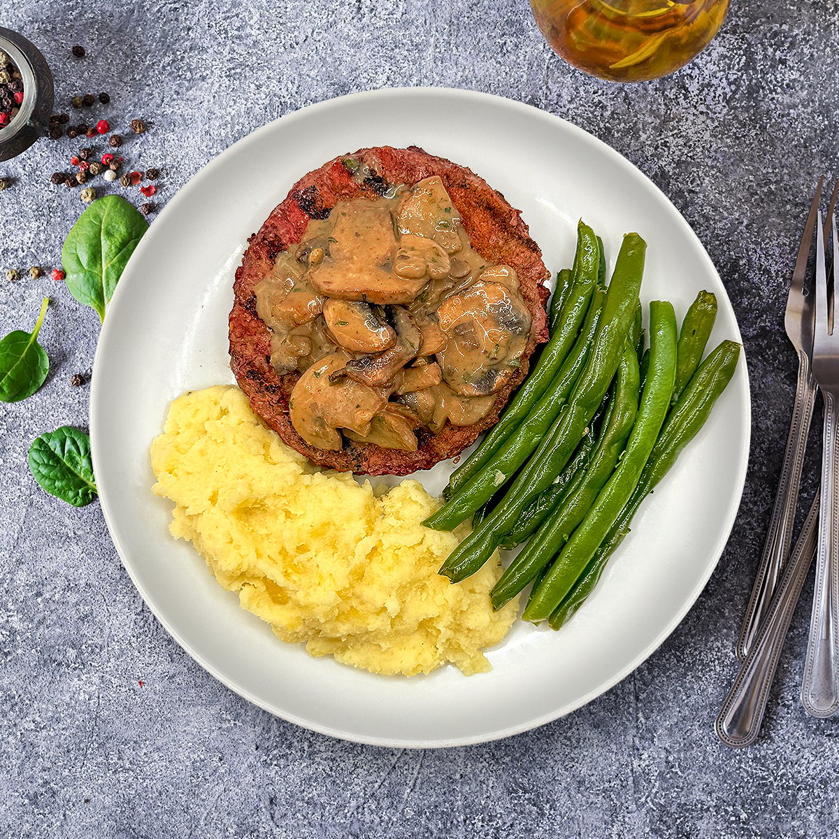 A juicy, seasoned burger patty smothered in a rich mushroom and shallot gravy, simmered in homemade chicken stock with Worcestershire, Dijon mustard, fresh thyme, and garlic.