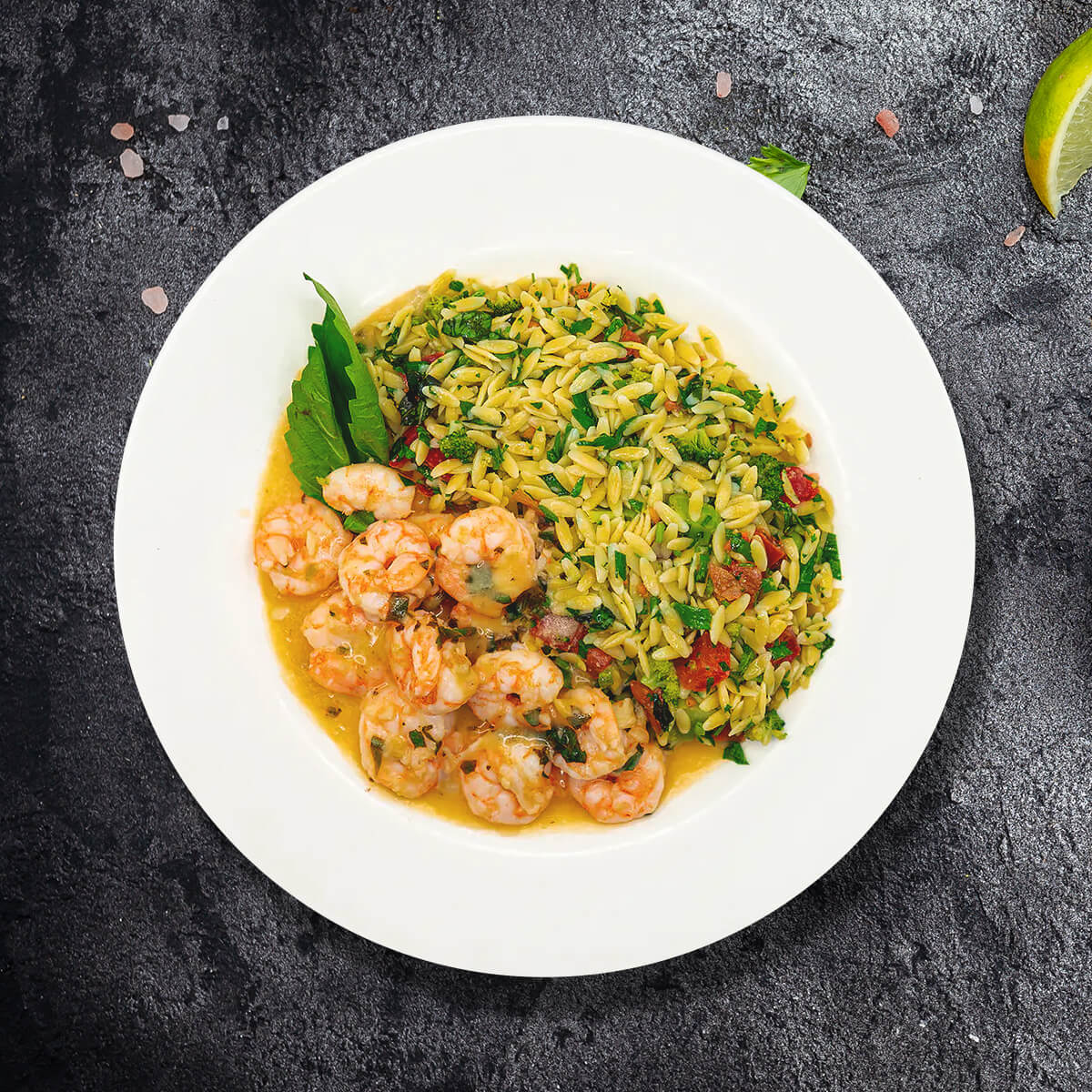 Golden-seared shrimp served over a garlicky orzo tossed with fresh spinach, broccoli, and juicy tomatoes brightened with lemon juice, fresh basil, and a hint of red pepper flakes.