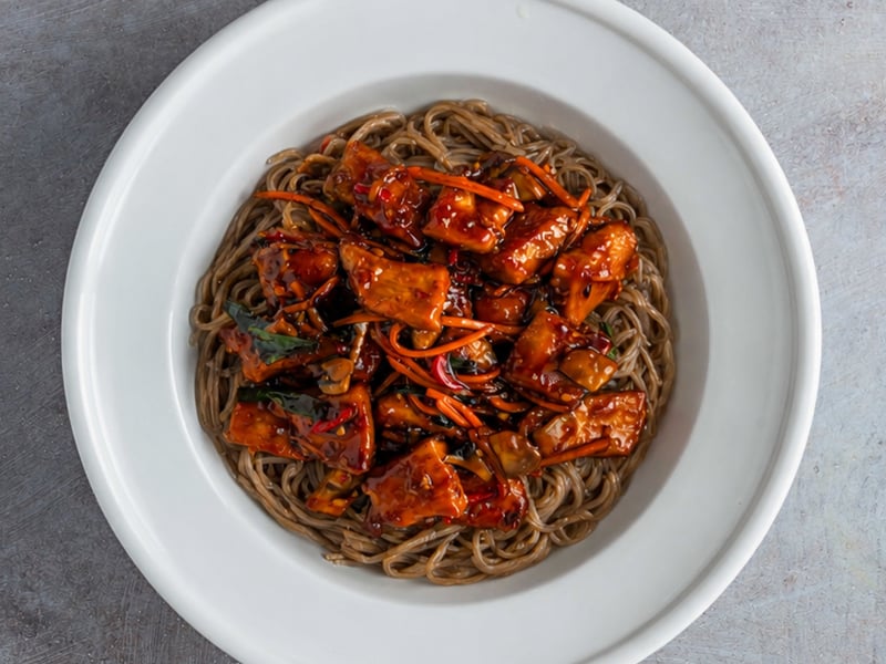 Juicy, antibiotic-free chicken breast paired with nutty organic soba noodles and sautéed crimini mushrooms, all tossed with vibrant shredded carrots and green scallions.