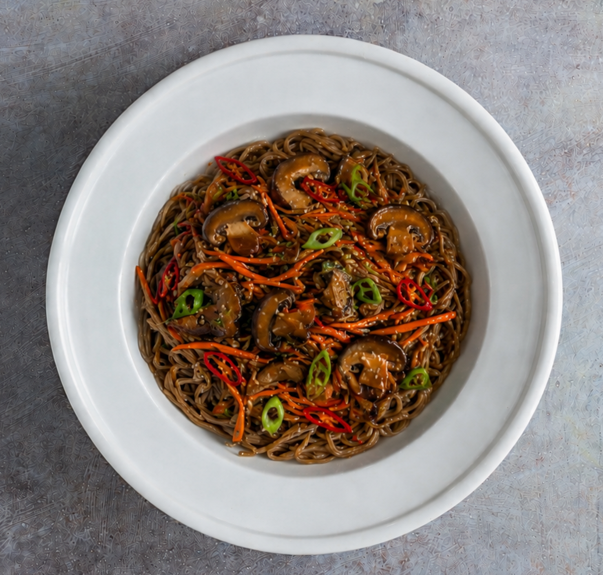 Nutty organic soba noodles tossed with sautéed crimini mushrooms, crisp shredded carrots, and fresh green scallions, all finished with a fragrant drizzle of sesame oil and a touch of sweet chili.