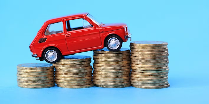 Red toy car on stacked coins