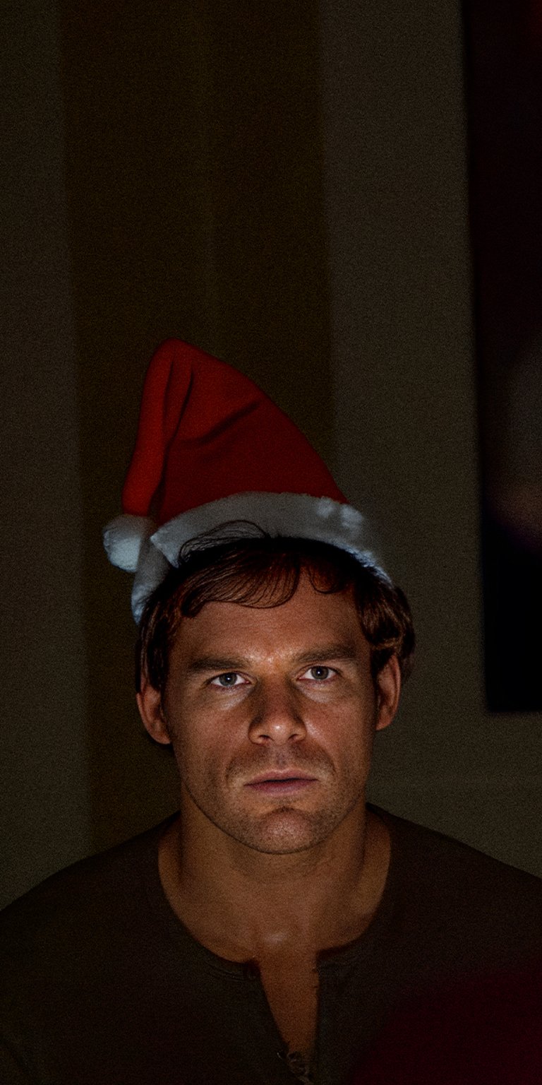 Dexter Morgan serious face wearing santa hat wallpaper