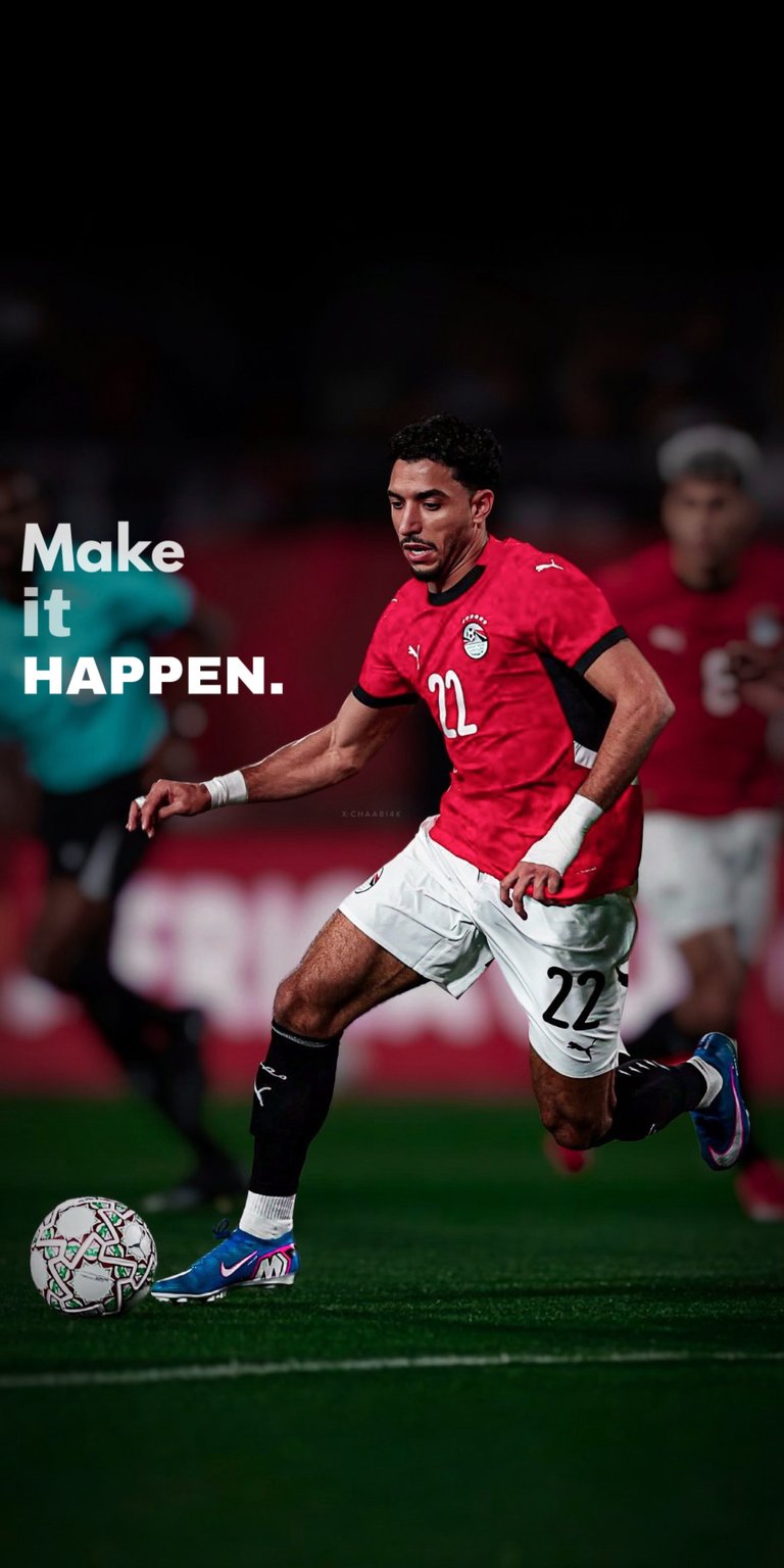 A powerful sports wallpaper featuring Liverpool legend Mohamed Salah in his red Egypt National Team kit. The design includes the bold motivational text "Make It Happen." Set against a blurred stadium background with high-contrast lighting, this image captures the focus and determination of one of football’s greatest icons.