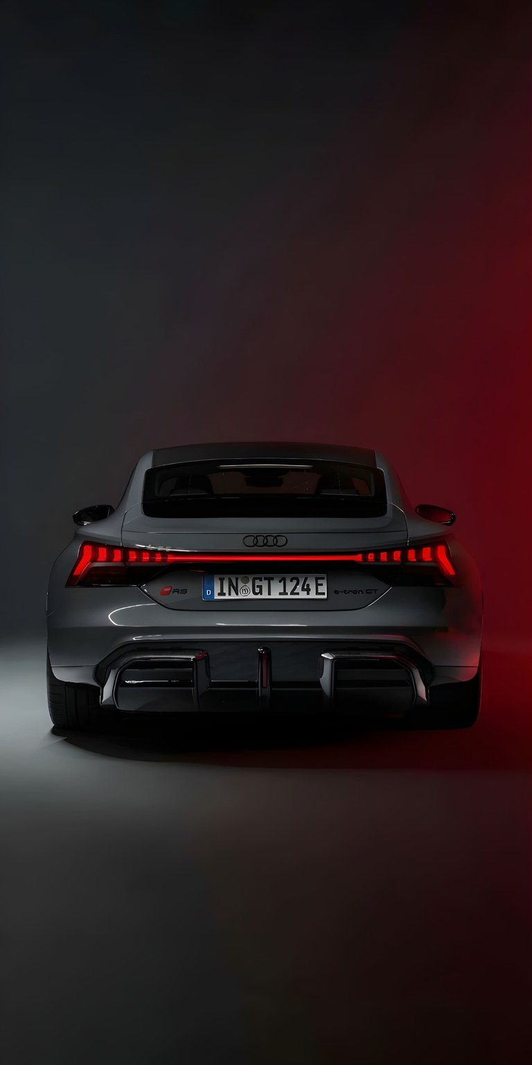 The sleek rear profile of an Audi e-tron GT showcasing its signature continuous tail light. This 3D wallpaper provides a modern electric vehicle aesthetic for your iPhone.
