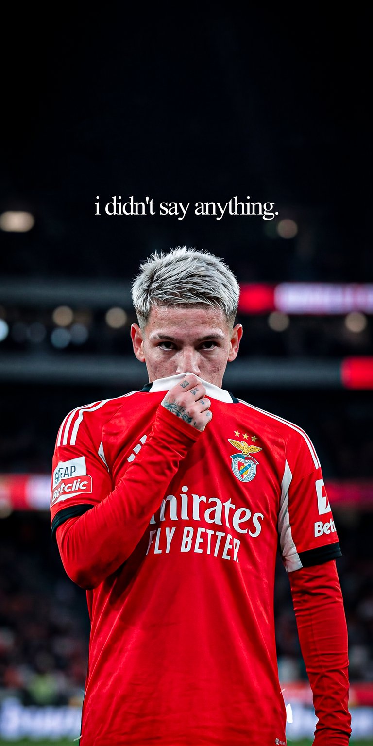 Gianluca Prestianni 4K wallpaper featuring the young winger in a red kit against a dark blurred stadium background. This wallpaper emphasizes focus, dramatic lighting, and strong contrast in a clean Aesthetic wallpapers style, perfect for iPhone lock screen and home screen.