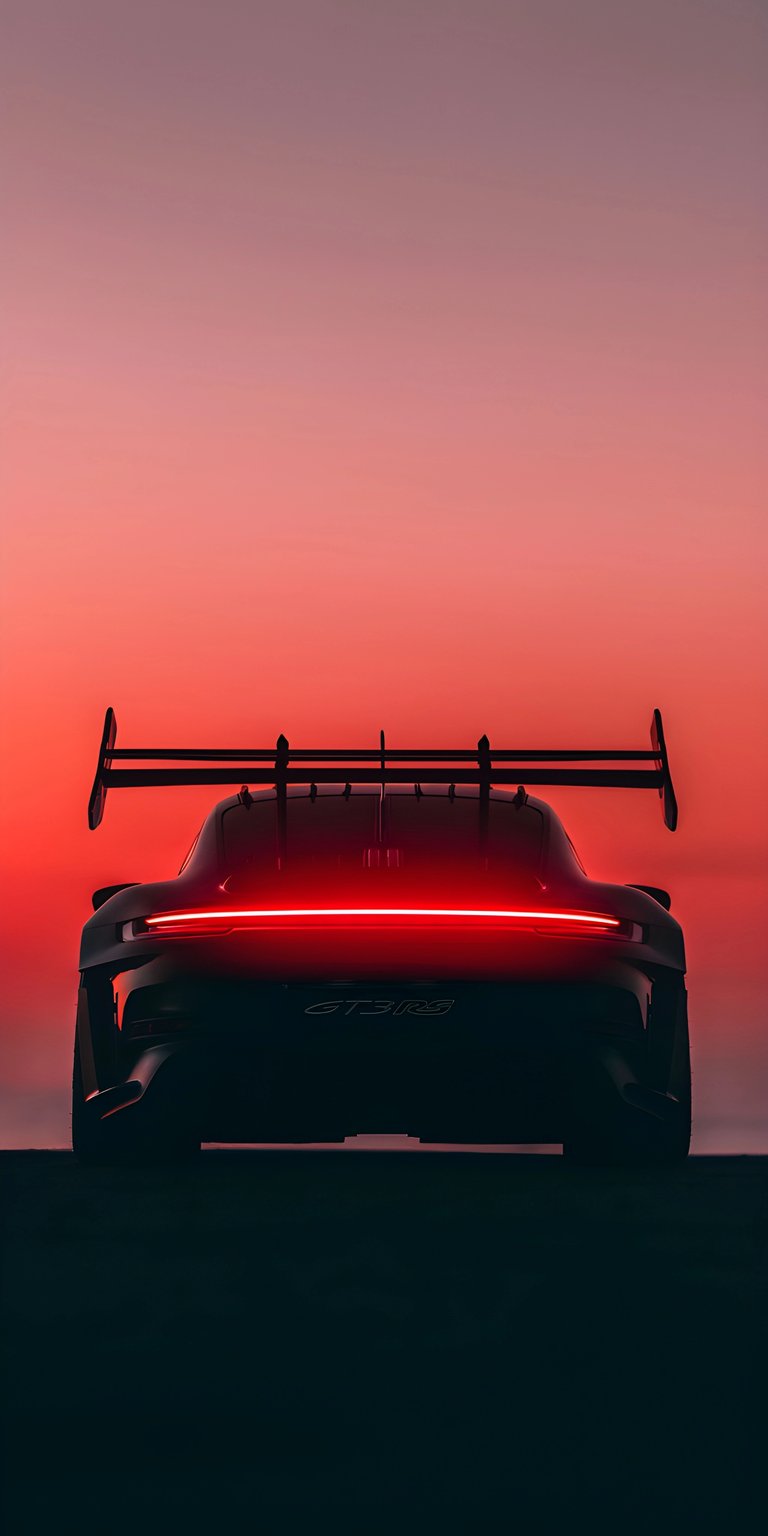 A dramatic rear-view silhouette of a Porsche GT3 RS set against a deep orange and pink sunset. The glowing red LED light bar and the aggressive profile of the swan-neck spoiler create a moody, cinematic "outrun" vibe perfect for car lovers and night-drive enthusiasts.