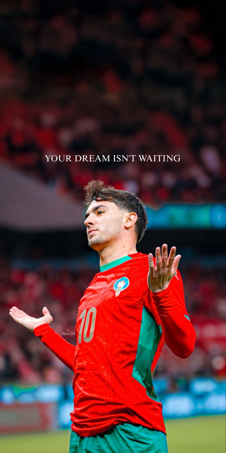 A stunning vertical wallpaper featuring Brahim Diaz in the red and green kit of the Morocco National Team (Atlas Lions). Brahim is captured in a moment of passion on the pitch with the inspiring text "YOUR DREAM ISN'T WAITING" overhead. Ideal for fans following his international journey and his career at Real Madrid.