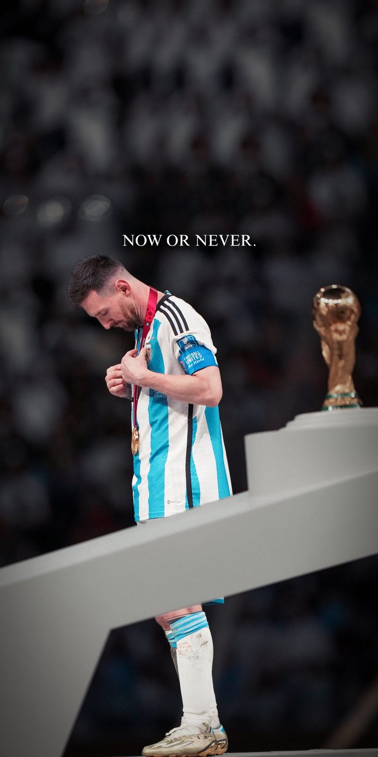 Celebrate the pinnacle of football history with this cinematic Lionel Messi wallpaper. Featuring Messi in the iconic Argentina kit alongside the FIFA World Cup trophy, this design includes the poignant text "NOW OR NEVER." It captures the emotional weight of his 2022 victory in stunning high definition.