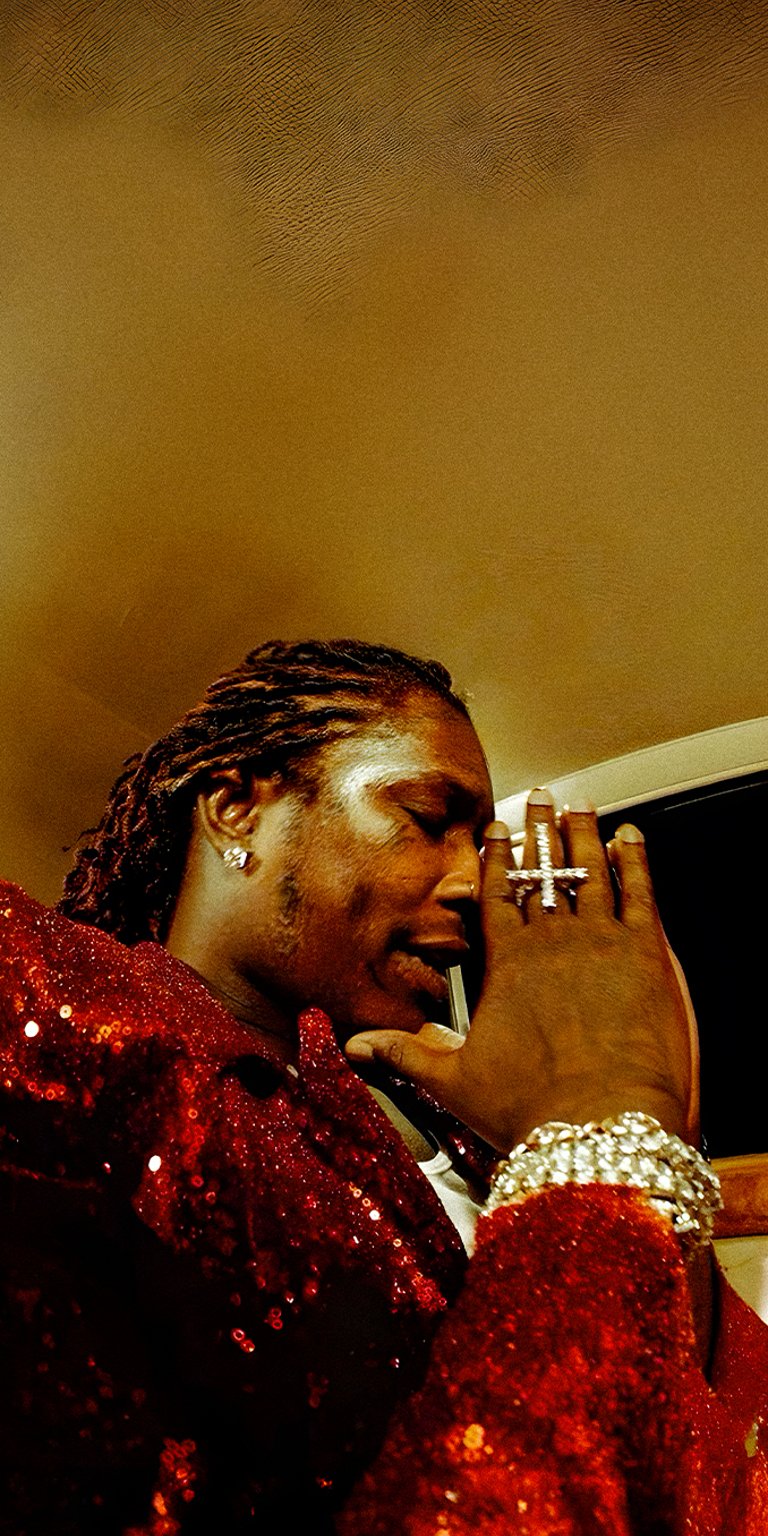 Young Thug praying while wearing red coat wallpaper