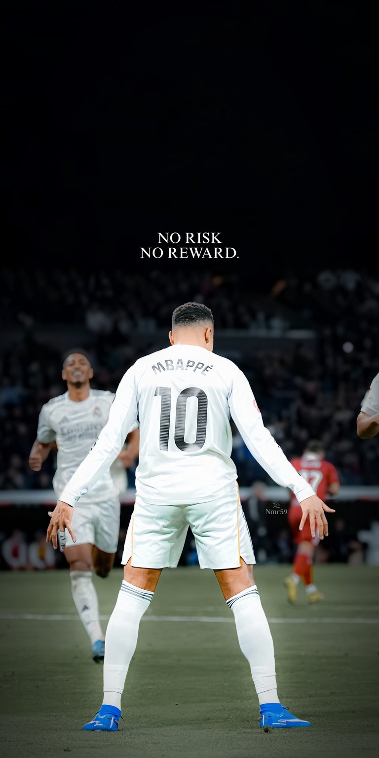 A back-view perspective of Kylian Mbappé wearing the legendary white Real Madrid "10" jersey. The wallpaper captures him looking out over the pitch with the bold statement "NO RISK NO REWARD" at the top. This minimalist yet impactful design celebrates his high-profile move to the Galácticos.