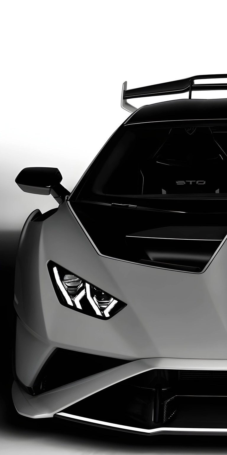 This high-contrast Lamborghini Huracán STO 4K wallpaper is optimized for OLED displays, featuring the aggressive front fascia of the Italian supercar. Designed specifically for iPhone, this sleek background highlights the signature LED headlights and aerodynamic hood vents against a deep black void.