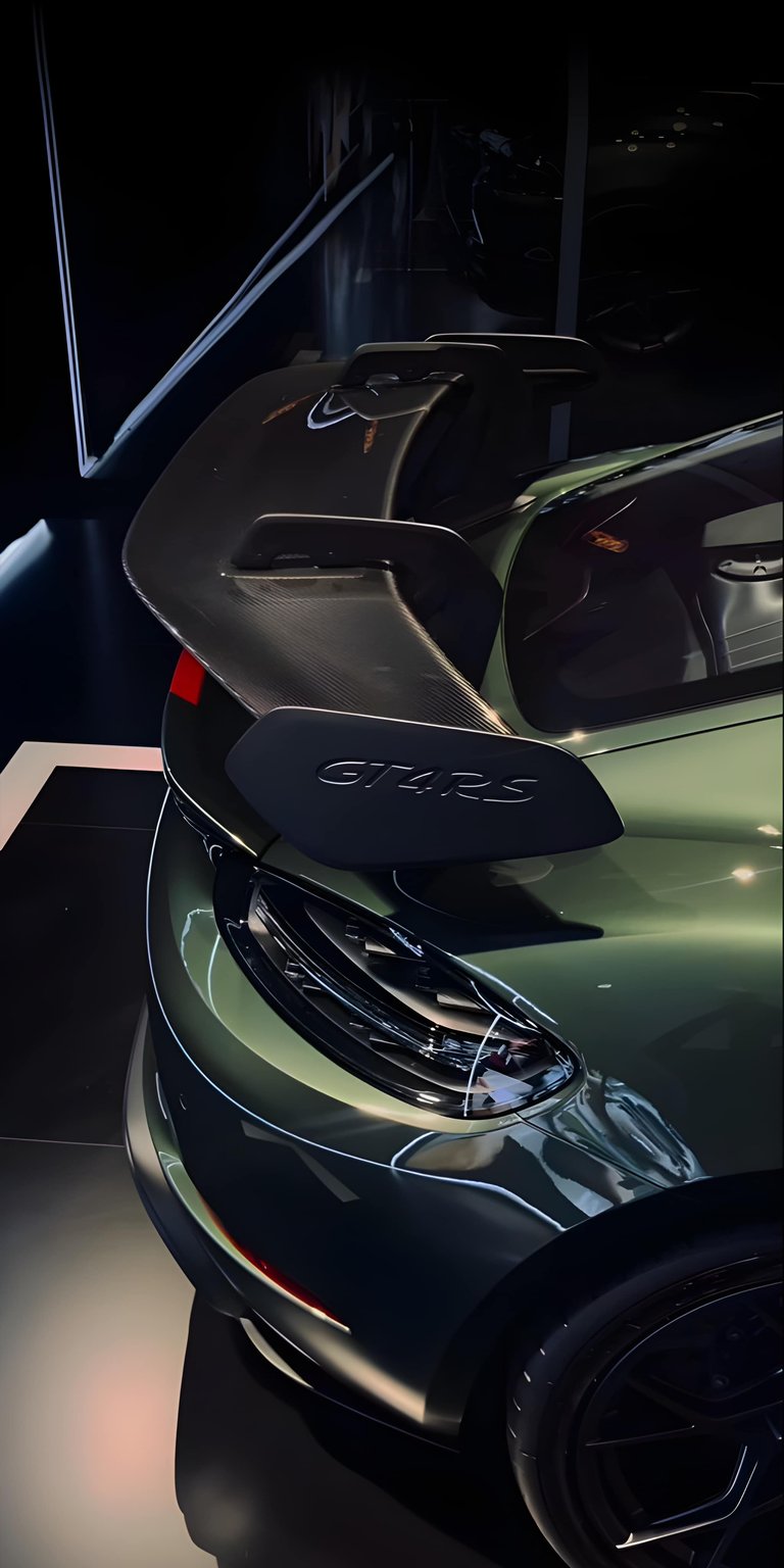 Download this stunning GT4RS wallpaper in 4K for your iPhone, showcasing its sleek, green body and distinctive black spoiler with GT4RS badging. The wallpaper captures the essence of automotive excellence.