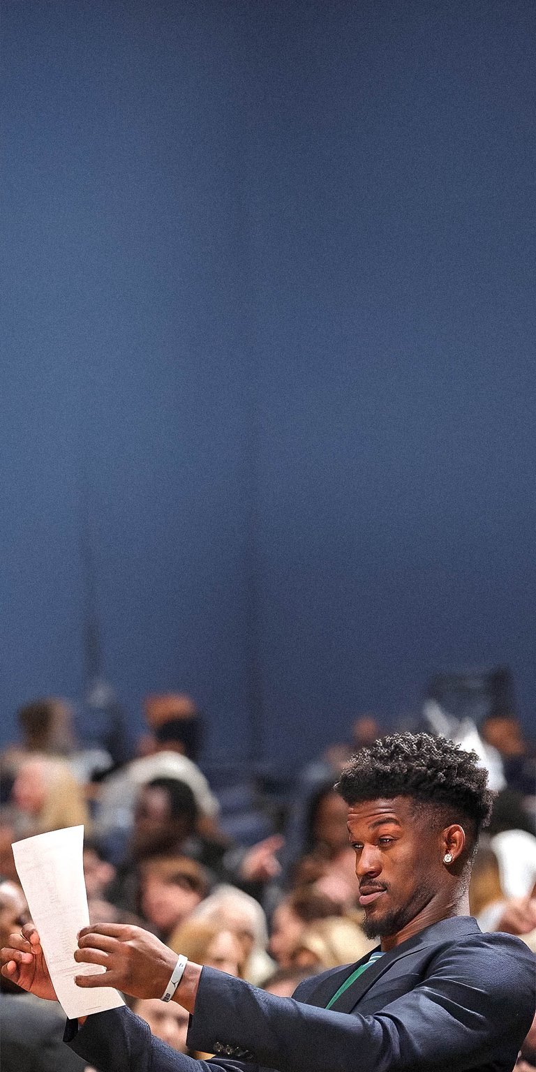 Man trying to read what is written on the paper wallpaper