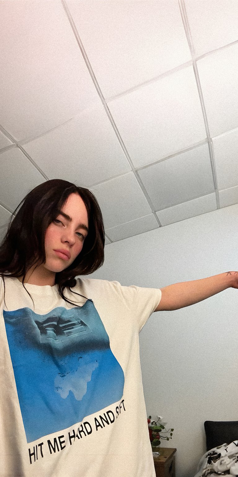 girl woman stand ceiling hand shirt arm out room bed bedroom selfie t shirt billie eilish hit me hard and soft