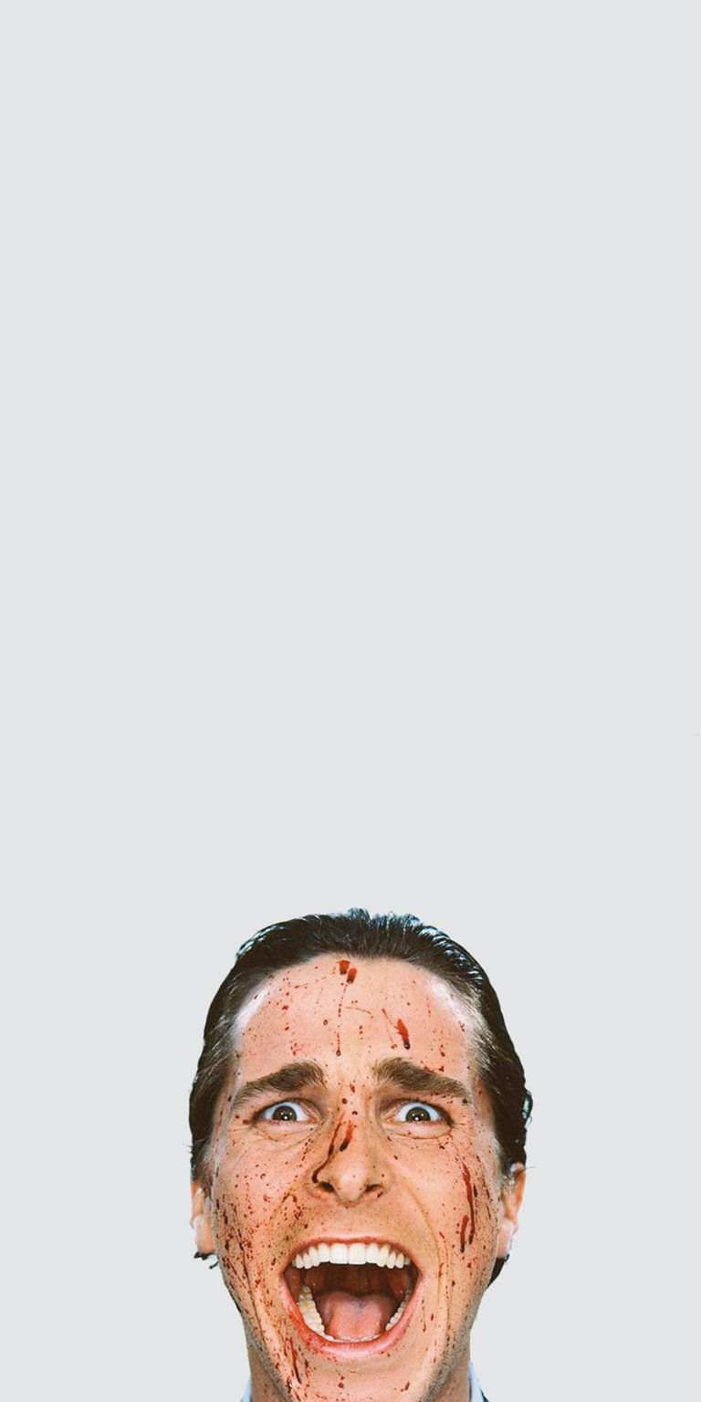 Get this Patrick Bateman 4K wallpaper for your iPhone, showcasing a maniacal expression and blood splattered across his face. This wallpaper is perfect for any fan looking for a unique mobile background.
