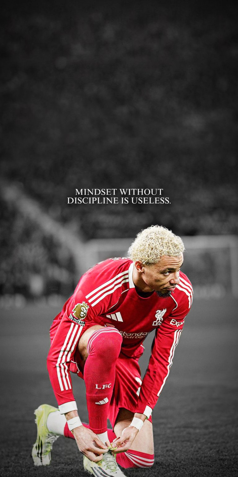 Ekitike 4K wallpaper created for OLED / AMOLED wallpapers, featuring deep black surroundings and strong stadium lighting contrast. This wallpaper is optimized for iPhone, highlighting a bold red kit, focused pre-match moment, and a disciplined, determined mood.