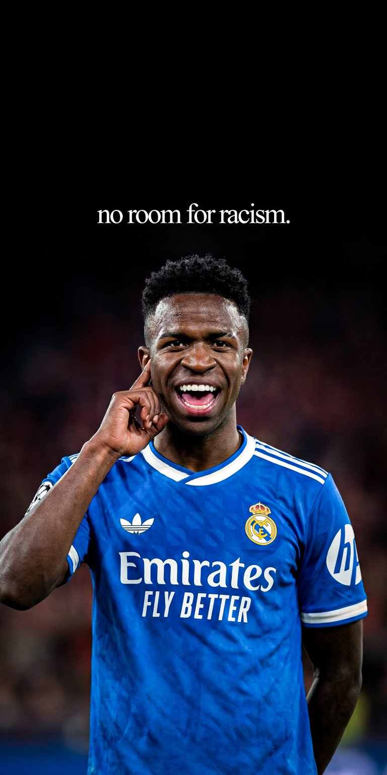 Vinicius Junior 4K Wallpaper featuring Vinícius Júnior in a bold blue jersey against a dark background. This aesthetic wallpaper for iPhone highlights strong stadium lighting and an intense expression, making the wallpaper perfect for lock screen and home screen setups.