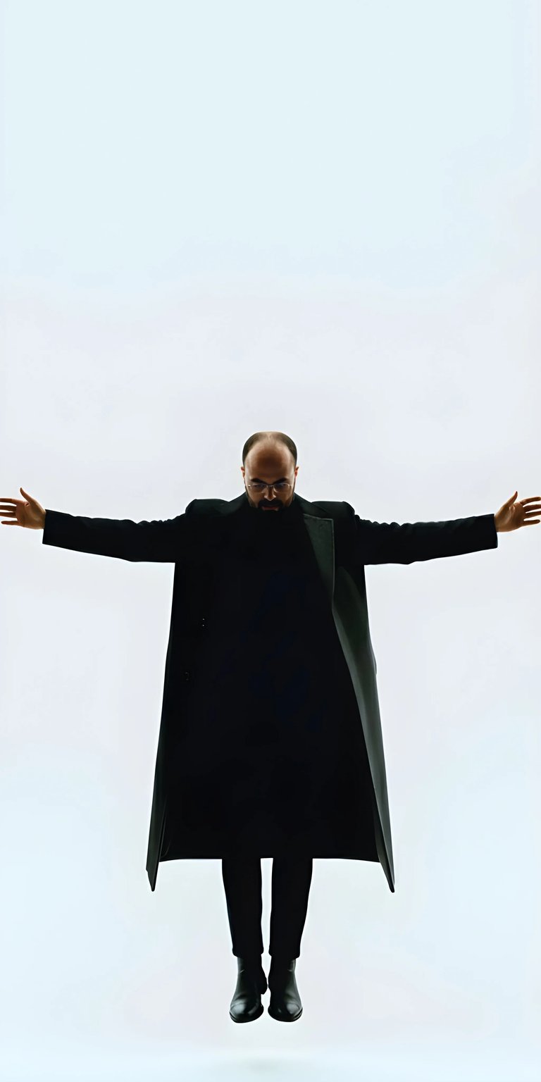 Danny Slicer Long Black Coat Static wallpaper featuring a minimalist composition with a clean white background and strong black contrast. This minimalist wallpaper for iPhone highlights a centered pose with outstretched arms, dramatic lighting, and deep shadows, making it ideal for lock or home screen use.