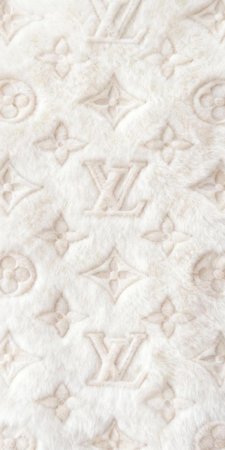 Get this Louis Vuitton 4K wallpaper for your iPhone, showcasing a plush, textured design. This stunning wallpaper features embossed LV logos, stylized flowers, and circular emblems for a luxurious touch.