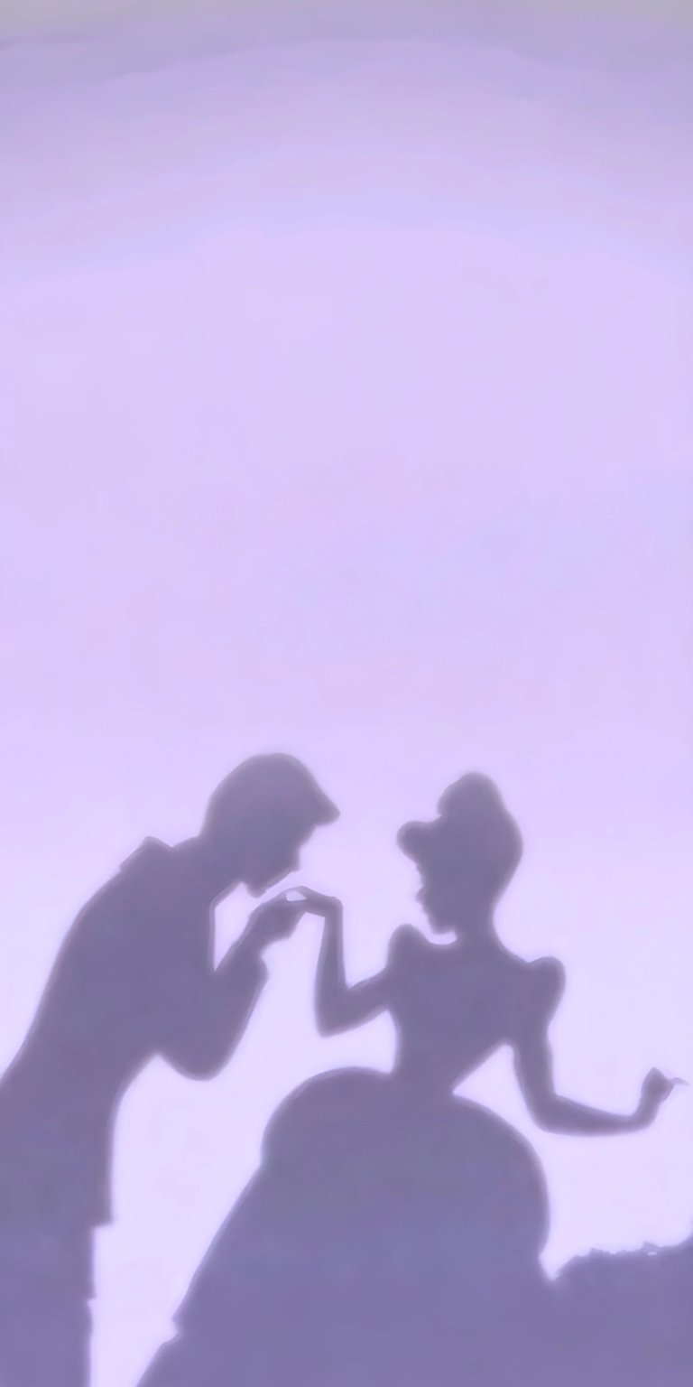 Download this stunning 4K Cinderella and Prince wallpaper for your iPhone! This wallpaper features the silhouette of the prince kissing Cinderella's hand with her hair up and her dress puffed.