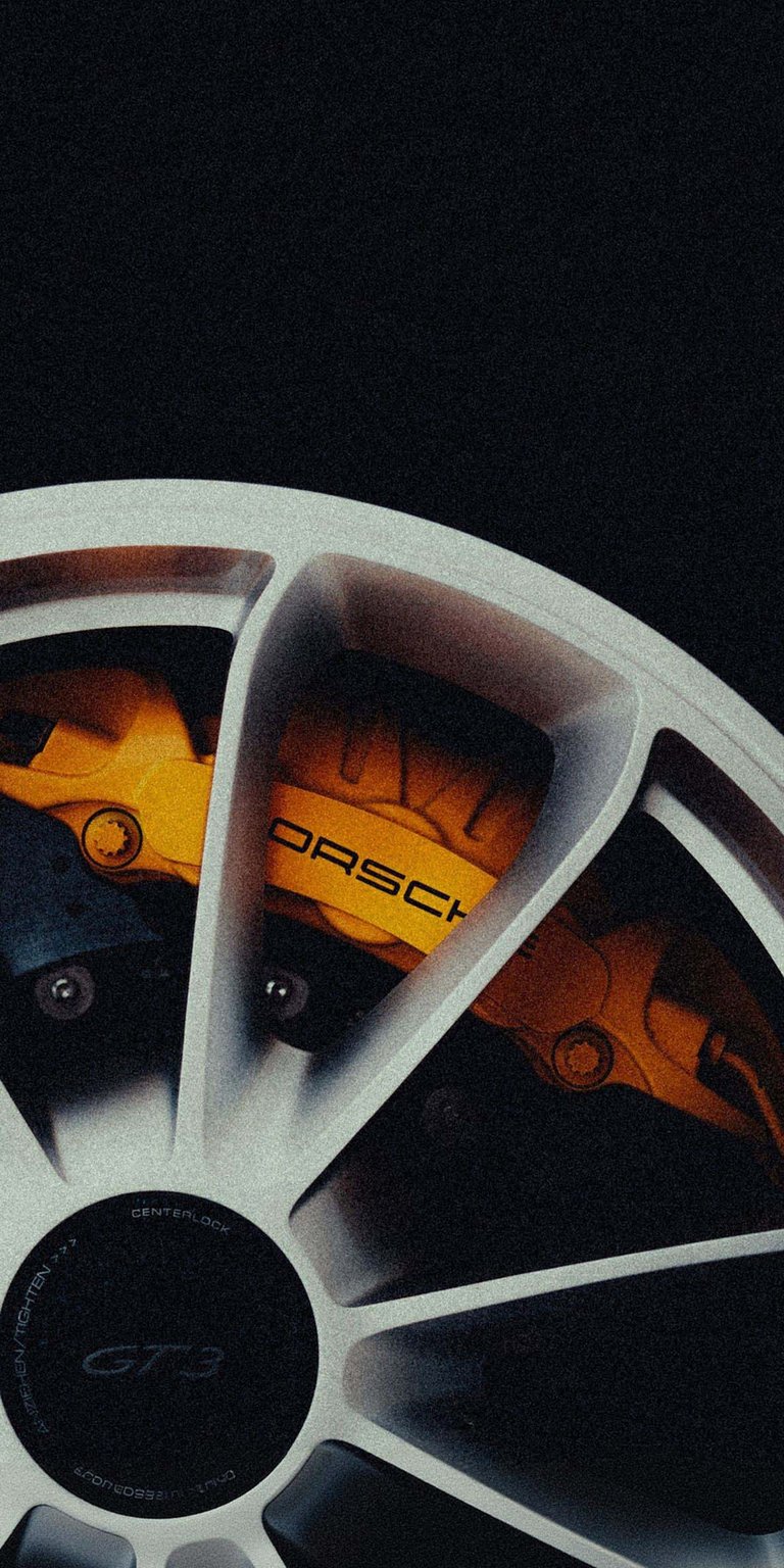Bring the track to your device with this 4K wallpaper featuring the iconic GT3 wheel and gold brake calipers. This crisp mobile wallpaper highlights metallic depth effects and premium engineering for a clean, minimalist lock screen.
