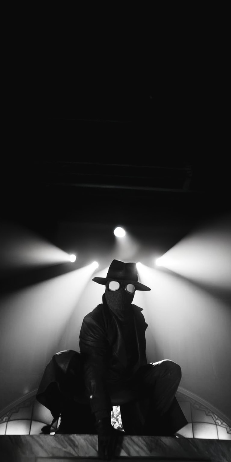 This high-contrast 4K wallpaper features Spider-Man Noir perched in a cinematic, low-light setting. Designed specifically for iPhone, this OLED / AMOLED wallpaper uses deep blacks and dramatic backlighting to create a moody, monochromatic aesthetic.