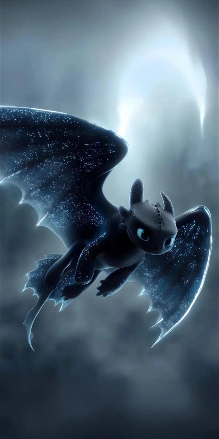 Download this stunning Toothless wallpaper in 4K resolution for your iPhone. This wallpaper features the Night Fury dragon with sparkling wings, a small fin, and piercing light-blue eyes.