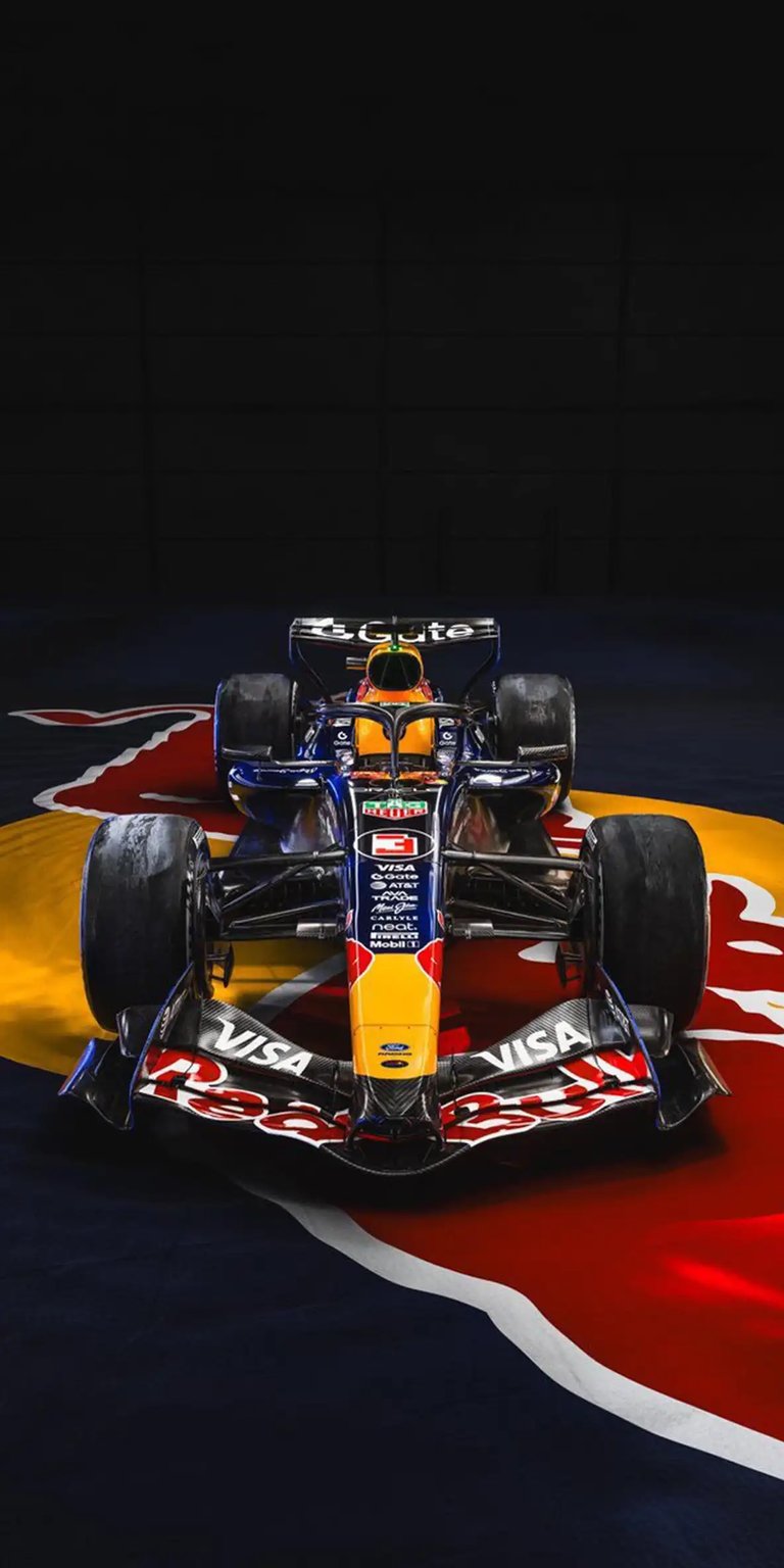 Elevate your screen with this 4K wallpaper showcasing the dominant Red Bull Racing Formula 1 car in a sharp, front-facing composition. This vibrant wallpaper is optimized for iPhone and highlights the intricate aero details and iconic navy-and-red livery.