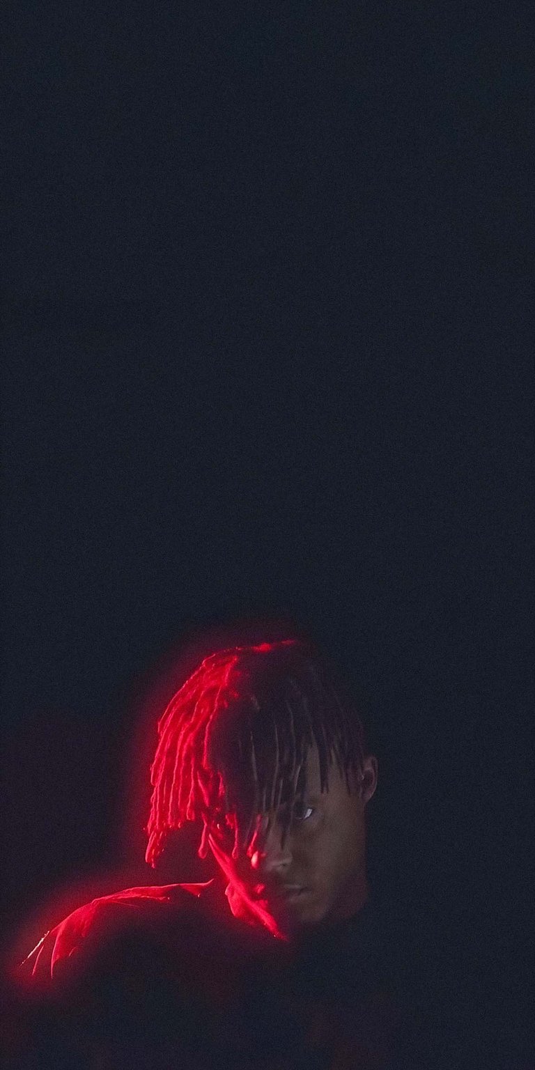 Juice WRLD with dark background and red light reflection wallpaper