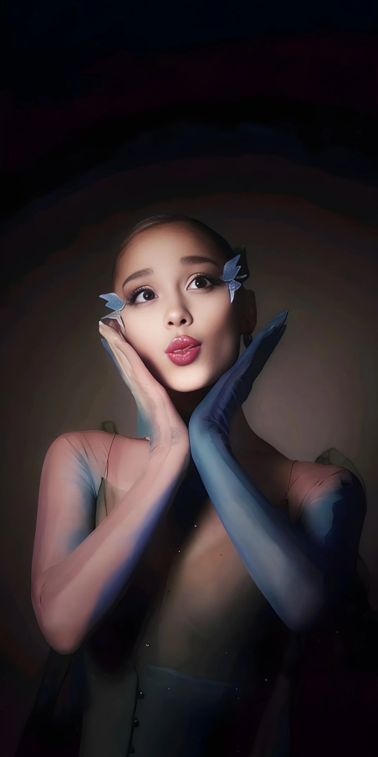 Download this Ariana Grande 4K wallpaper for your iPhone! This wallpaper features Ariana with butterfly clips, pink lipstick, and blue gloves.