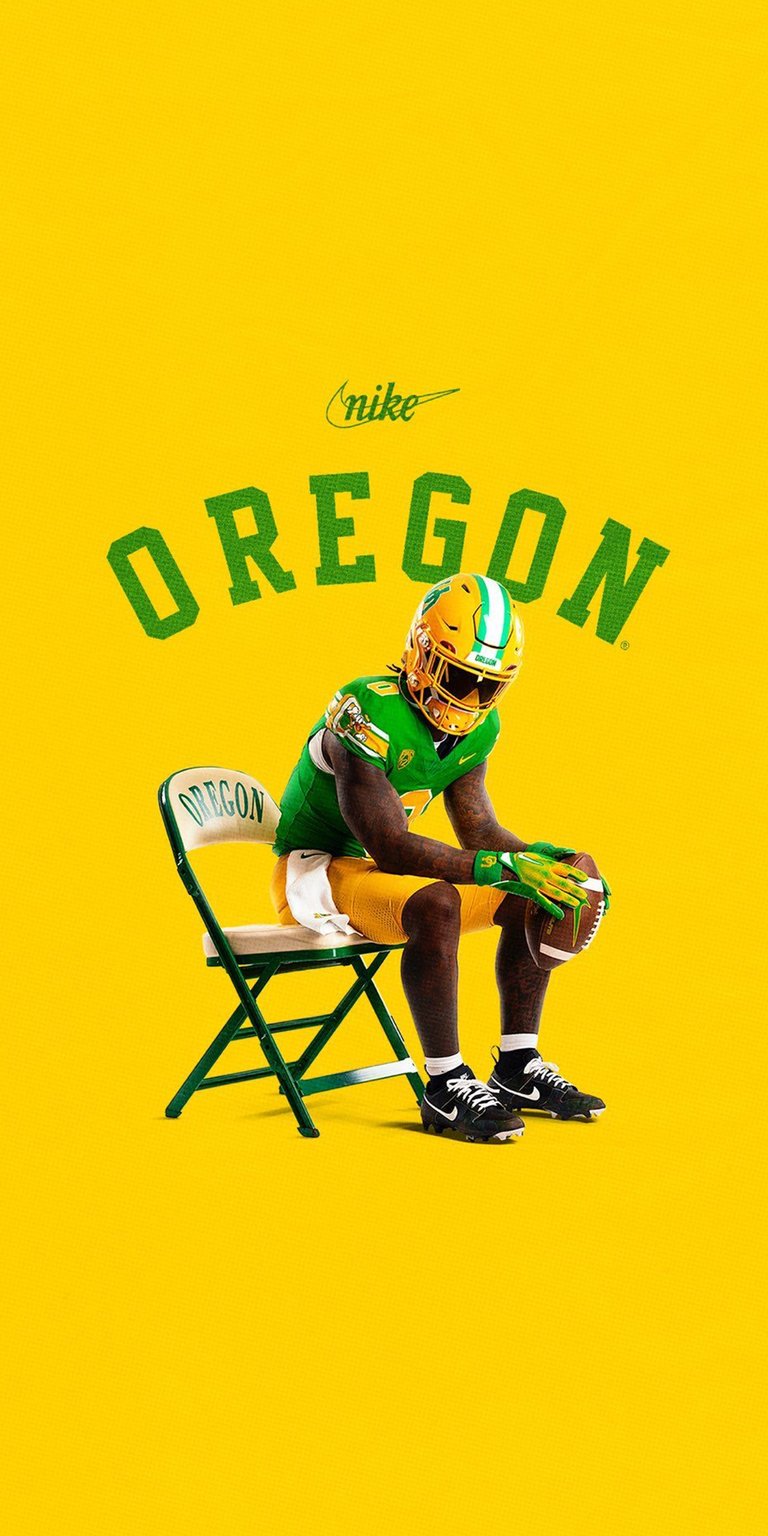 Get hyped with this Oregon Football 4K wallpaper for your iPhone, showcasing the player on a folding chair against a vibrant yellow background. This stunning wallpaper features the player holding a football, sporting bright green and yellow gloves and helmet.