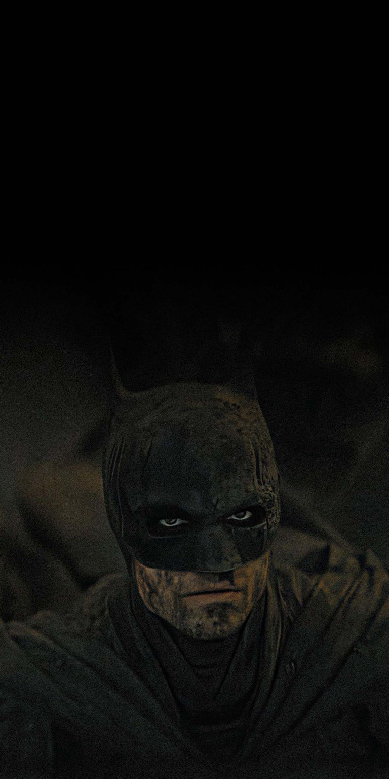 Download this Batman 4K wallpaper for your iPhone, featuring a close-up of his masked face with intense eyes and a weathered, textured cowl. This stunning wallpaper captures the dark and gritty essence of the Caped Crusader.