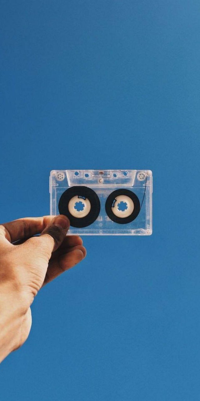 Cassette tape man holding sky wallpaper