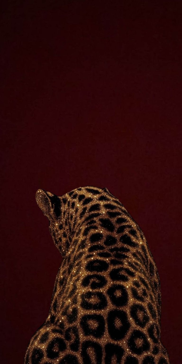 Leopard wallpaper designed in an aesthetic wallpapers style for iPhone, showcasing a dramatic animal portrait with artistic flair. This wallpaper features deep burgundy tones, glittering golden textures, and strong depth, creating a bold and luxurious wallpaper mood.
