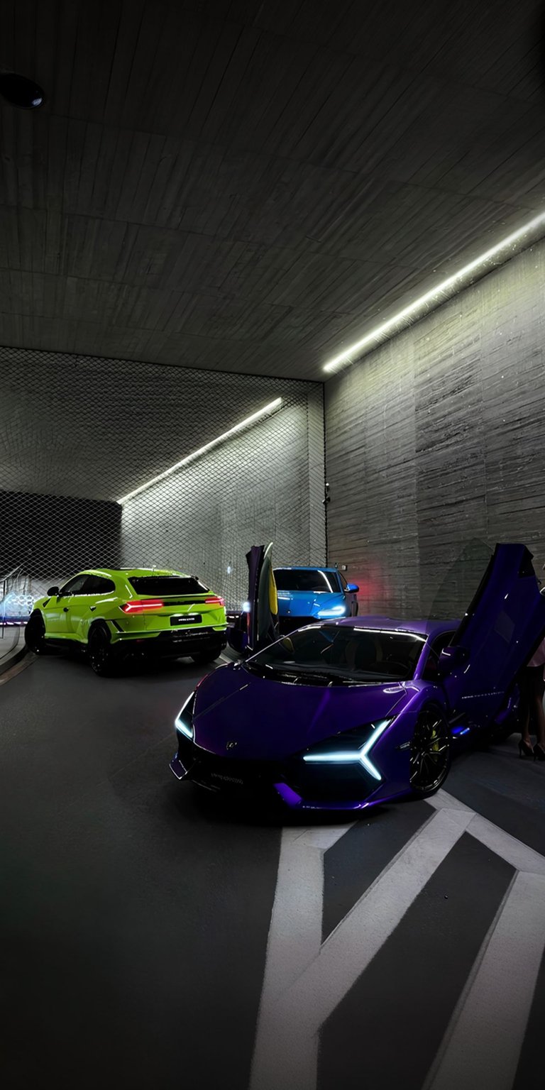 Experience the thrill of exotic cars with this stunning Lamborghini wallpaper for your iPhone. The 4K wallpaper showcases a purple Lamborghini with its doors open, alongside a bright green SUV and blue car, all parked under sleek modern lighting.