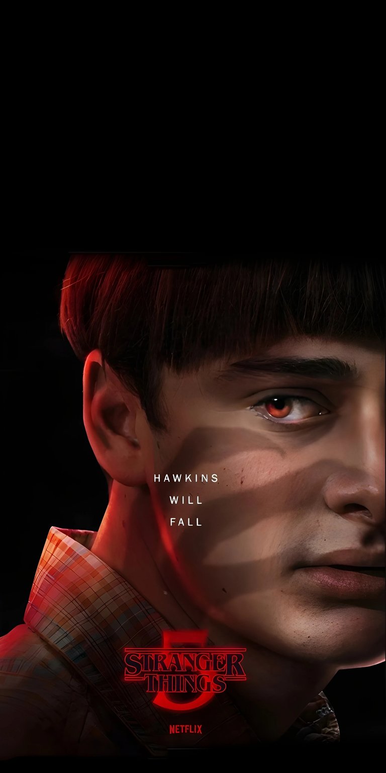 Download this incredible Will Byers 4K wallpaper for your iPhone, featuring a sinister red eye and the ominous "Hawkins Will Fall" shadow. This wallpaper captures the essence of Stranger Things with its plaid collar and dark, foreboding aesthetic.