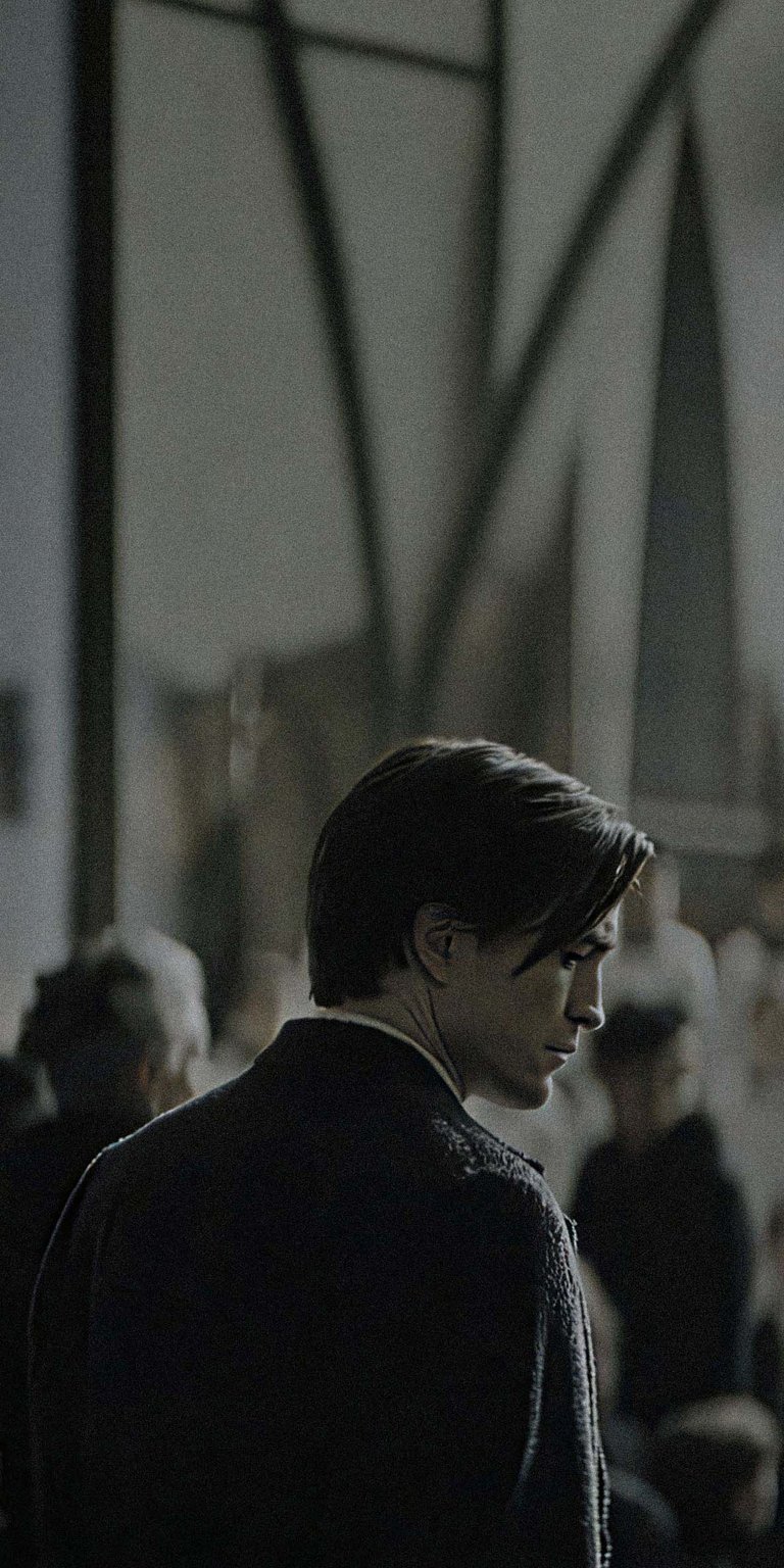 Get this Robert Pattinson 4K wallpaper for your iPhone, highlighting his sharp profile in a dark coat, amidst a crowd with light streaming from above. This wallpaper is perfect for any fan.