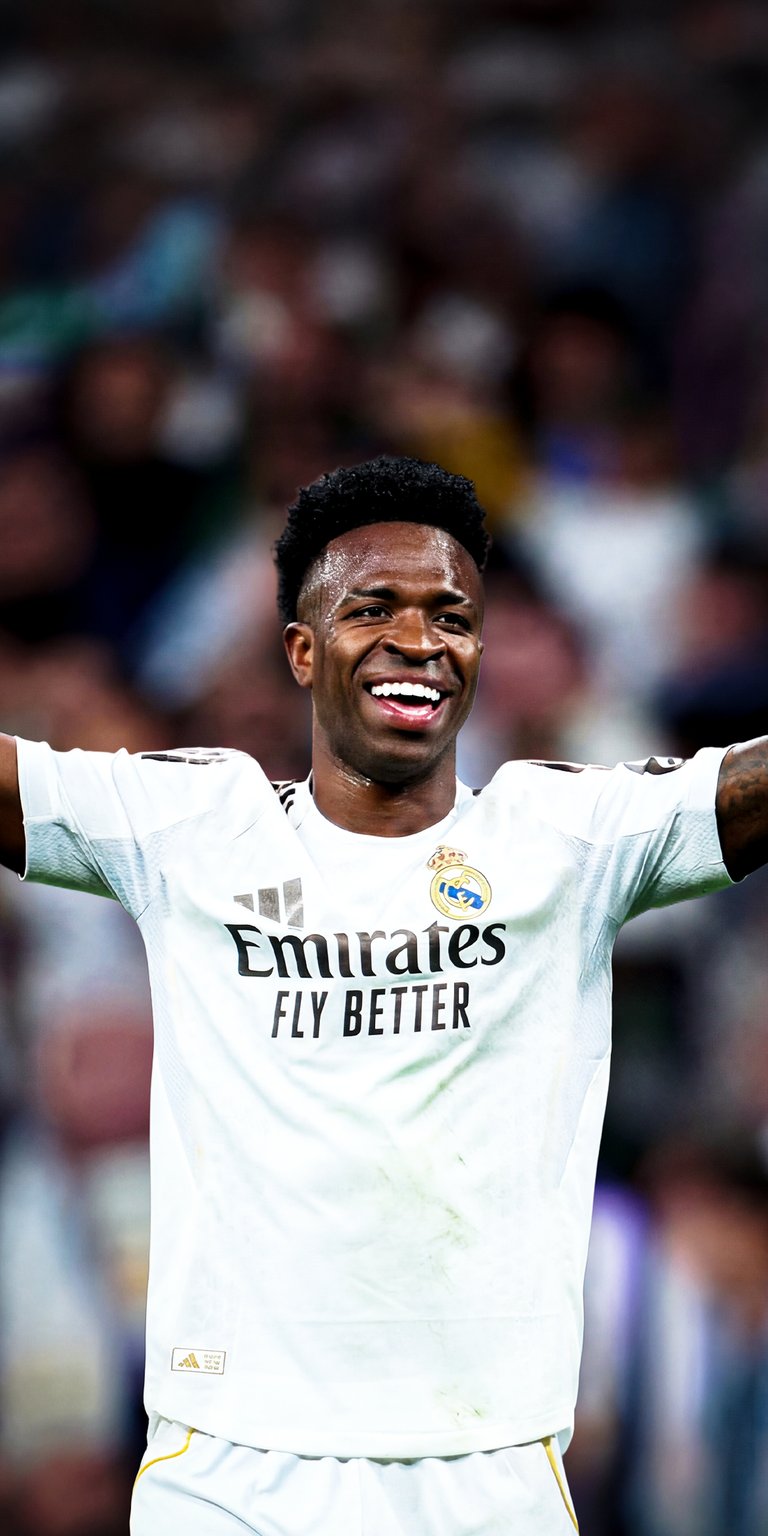 Bring the energy of Vini Jr to your device with this 4K wallpaper featuring his iconic smile in the Real Madrid home kit. This iPhone wallpaper perfectly renders the texture of the Madrid jersey and the joyful emotion of one of the world's best wingers.