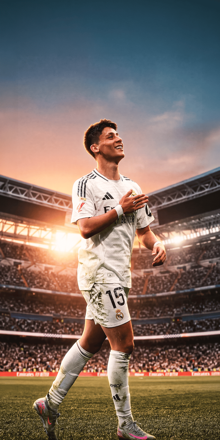 An aesthetic wallpaper featuring Nico Paz in a white Real Madrid kit looking toward the stadium lights. This high-quality 4K wallpaper captures the warm, sun-drenched atmosphere of the pitch for your iPhone.