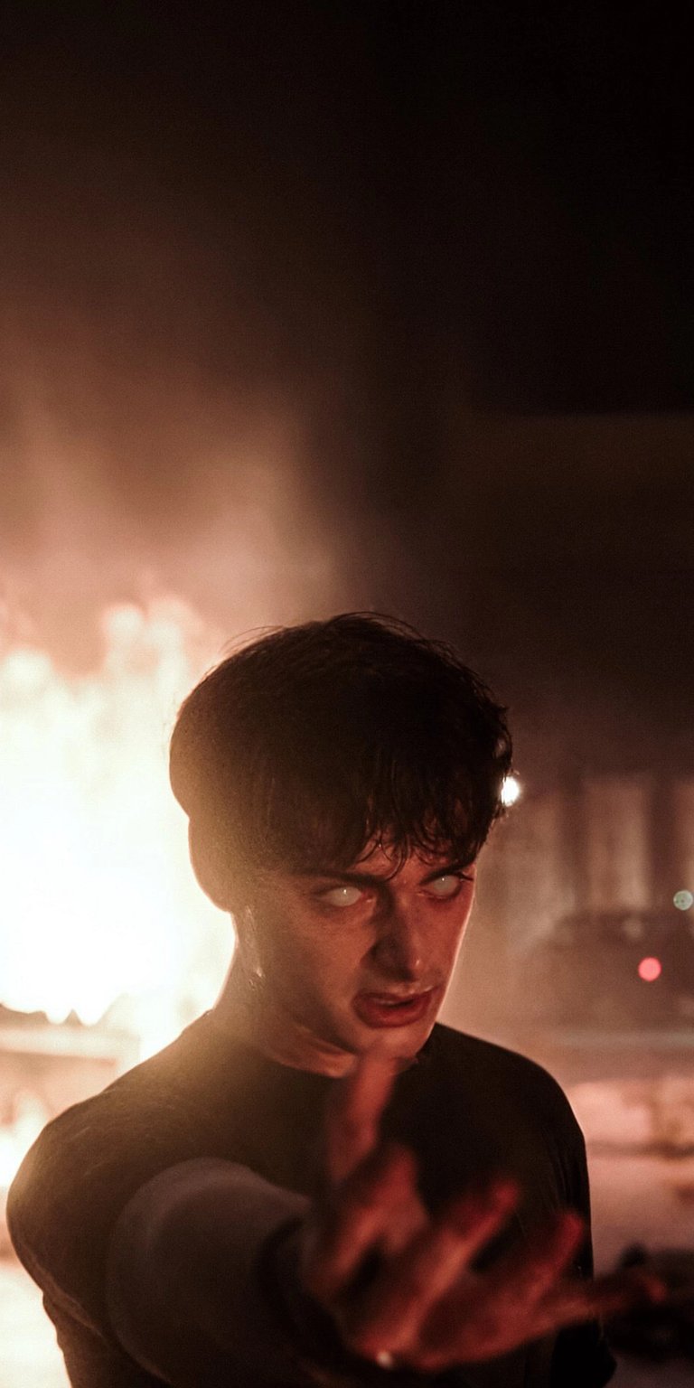 Download this striking Stranger Things wallpaper in 4K for your iPhone, showcasing his eerie white eyes, dark hair, and outstretched hand amidst the smoky backdrop. This wallpaper captures a captivating and mysterious scene.