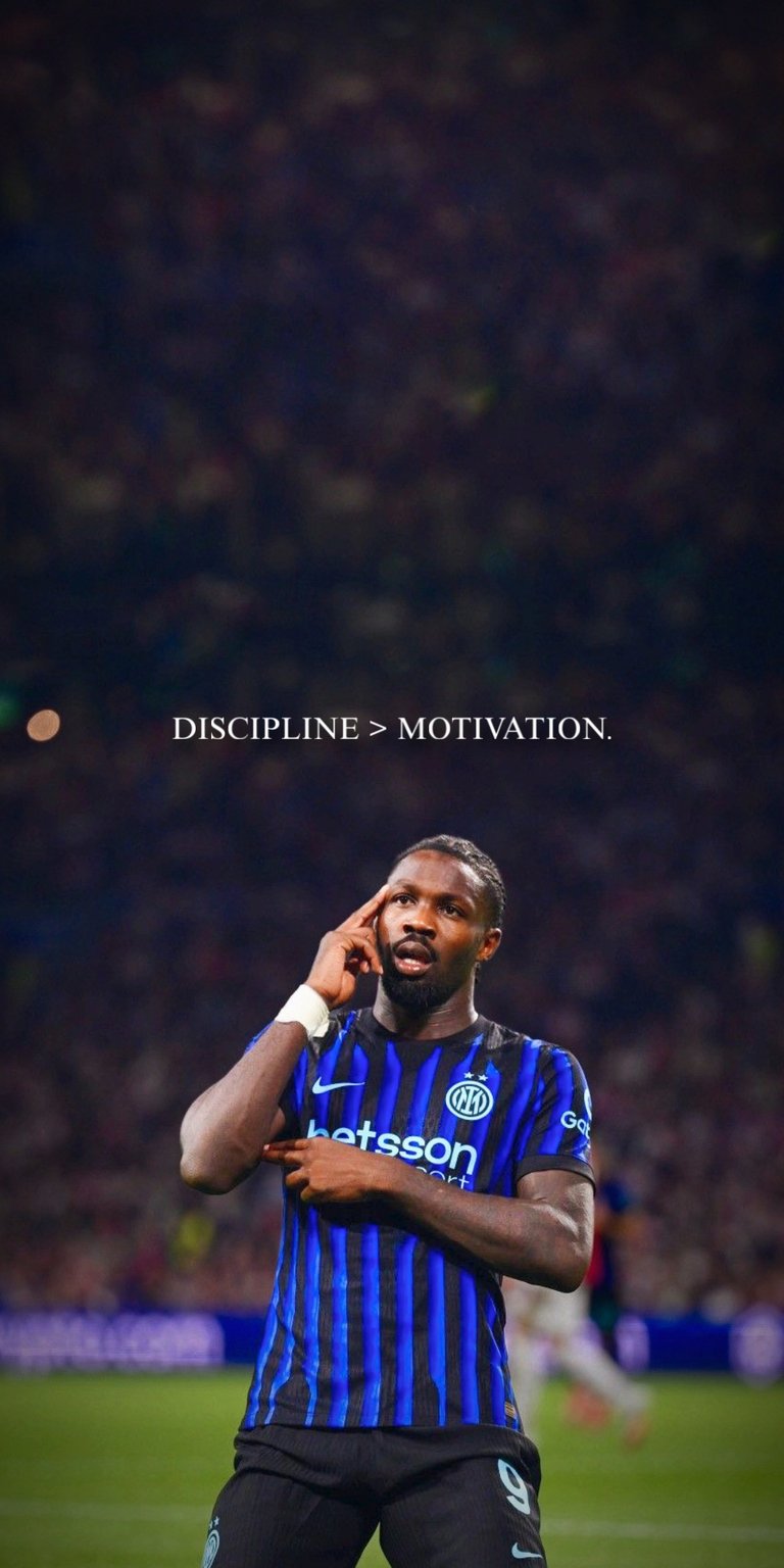 A high-definition sports wallpaper featuring Inter Milan forward Marcus Thuram in the iconic Nerazzurri blue and black kit. The image captures his signature celebration with the motivational text "DISCIPLINE > MOTIVATION" centered at the top. The background features a blurred, atmospheric stadium crowd, perfect for fans of Serie A and Italian football.