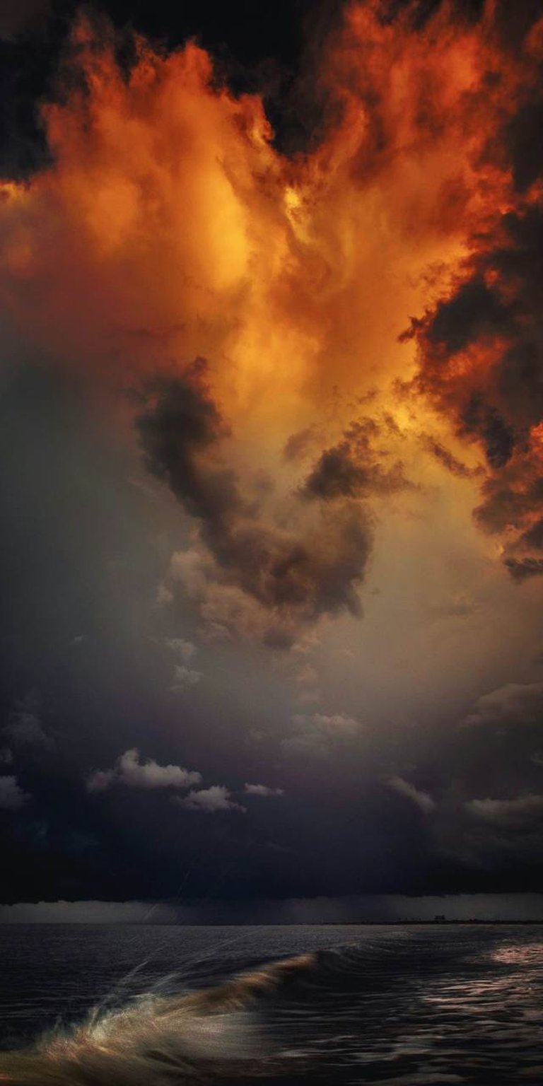 Red clouds and splashing ocean phone wallpapers