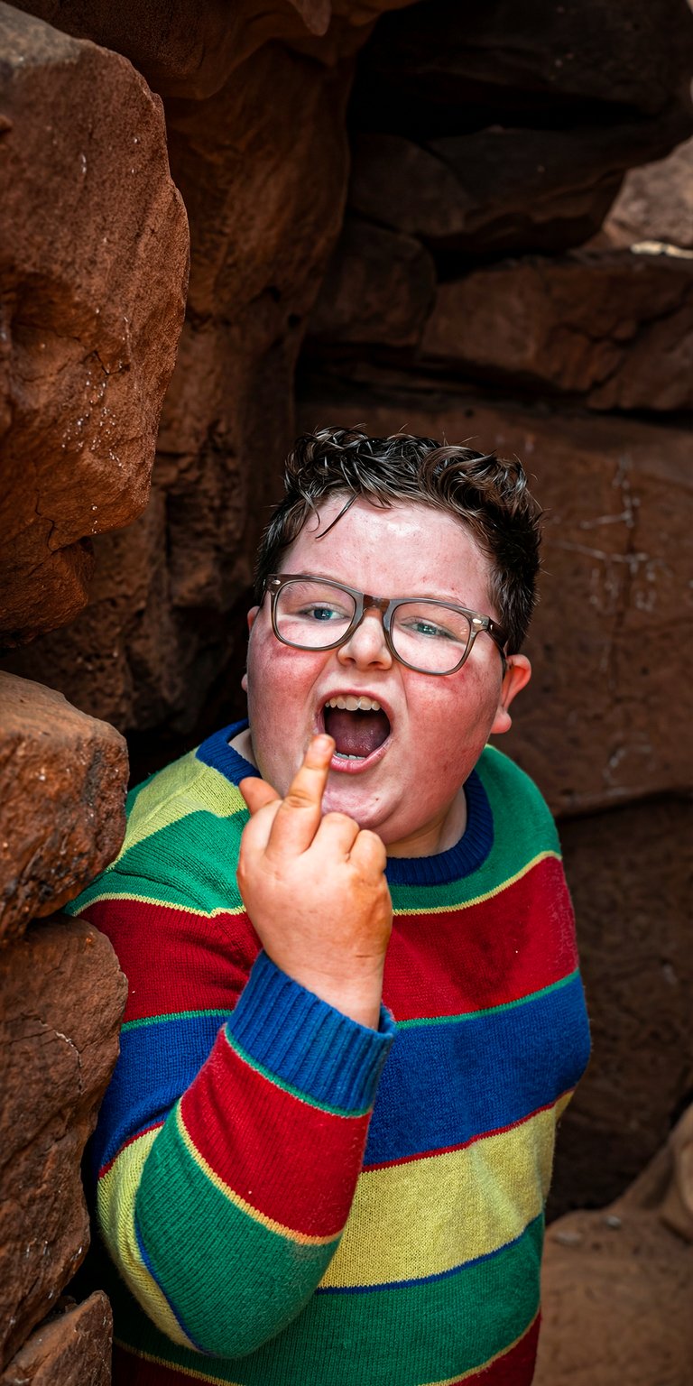 Featuring the scene-stealing Derek Turnbow (Jake Connelly) from Season 5. This 4K wallpaper captures the character's "Dipshit Derek" persona, sporting his signature striped sweater and thick glasses while delivering his famously rebellious attitude.