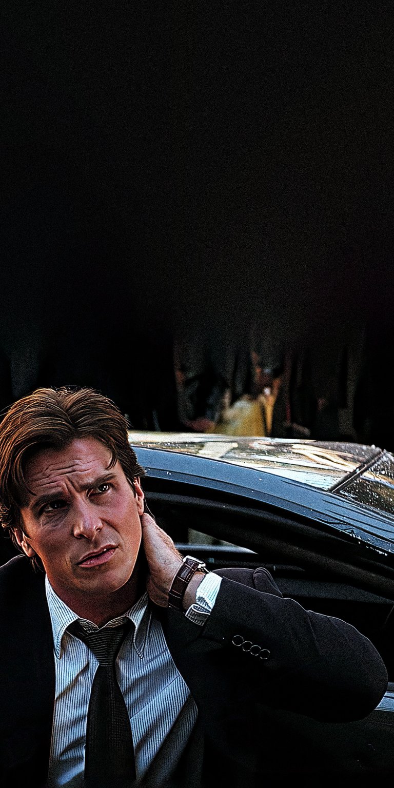 Get this Christian Bale 4K wallpaper for your iPhone, showcasing him in a dark suit, with a visible watch and a car's window covered in raindrops. This wallpaper is sure to look fantastic on your mobile device.